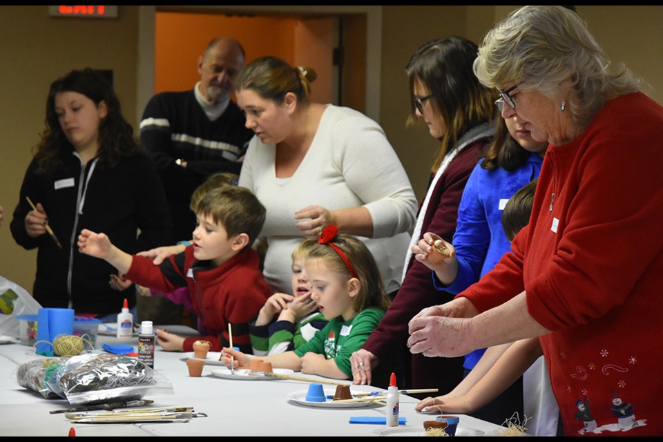 Families enjoy making crafts at the Merry Little Christmas event, Dec. 15. Miriam King/Bradford Today