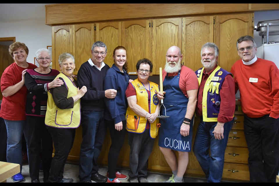 Gavin Maclean (holding potato masher) and fellow volunteers prepare to serve up a Christmas Day community meal. Miriam King/Bradford Today