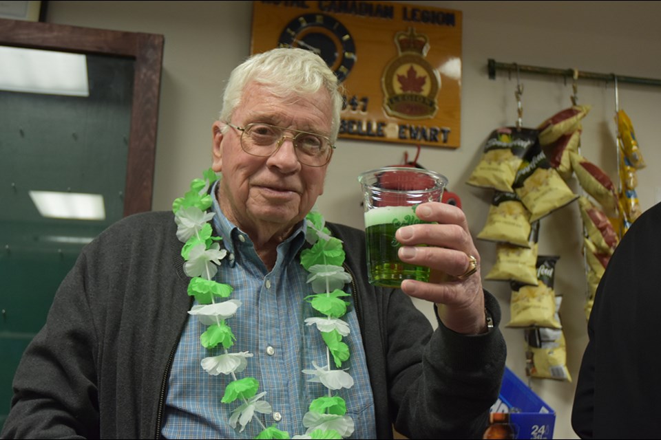 Brian Bethell raises a glass of green beer at the Lefroy-Belle Ewart Legion, Saturday night. Miriam King/Bradford Today