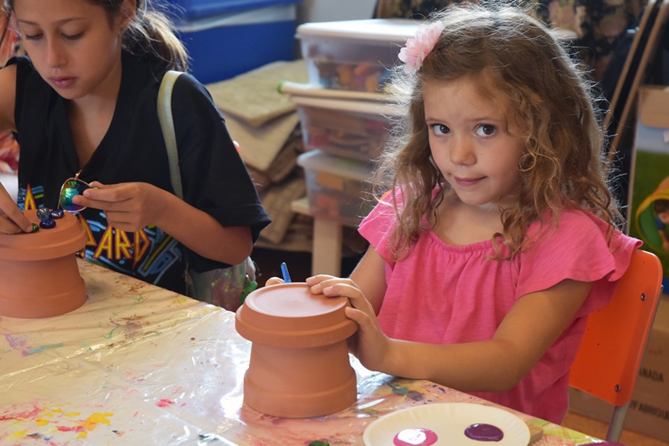 Young gardeners decorated their 'toad houses' with paint, shells and gems, at the BWG Public Library. Miriam King/Bradford Today