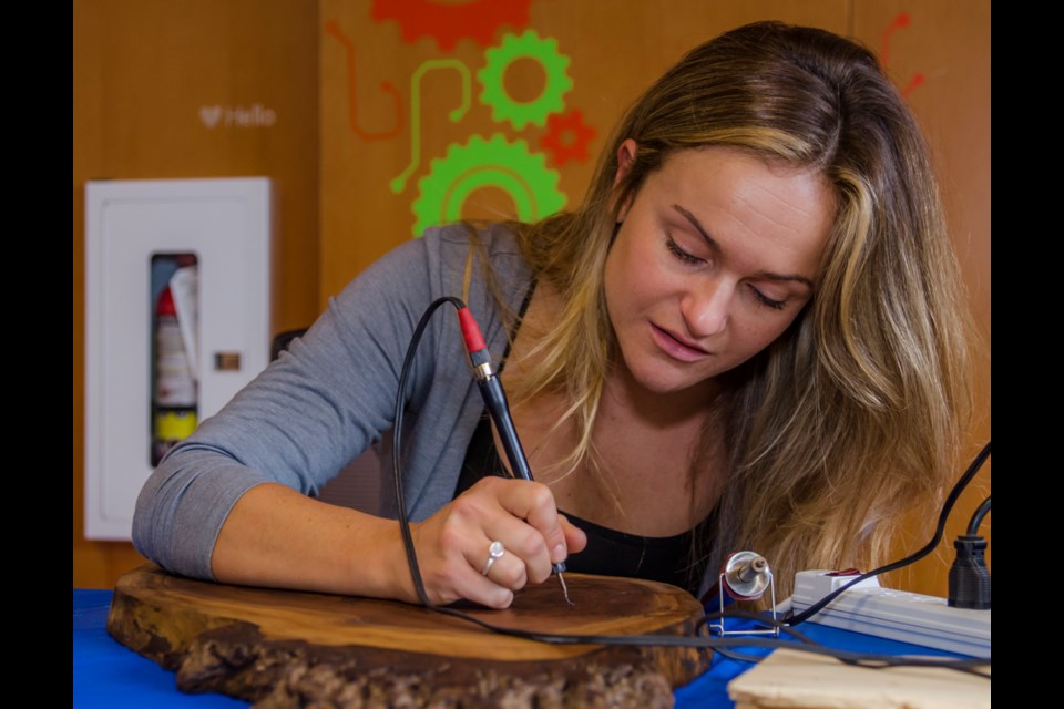 Alex Glueckler of Gluck Design & Craft demonstrates pyrography, the creation of images with heat, during MakerFest '19 at the Innisfil IdeaLAB & Library. Dave Kramer for BradfordToday