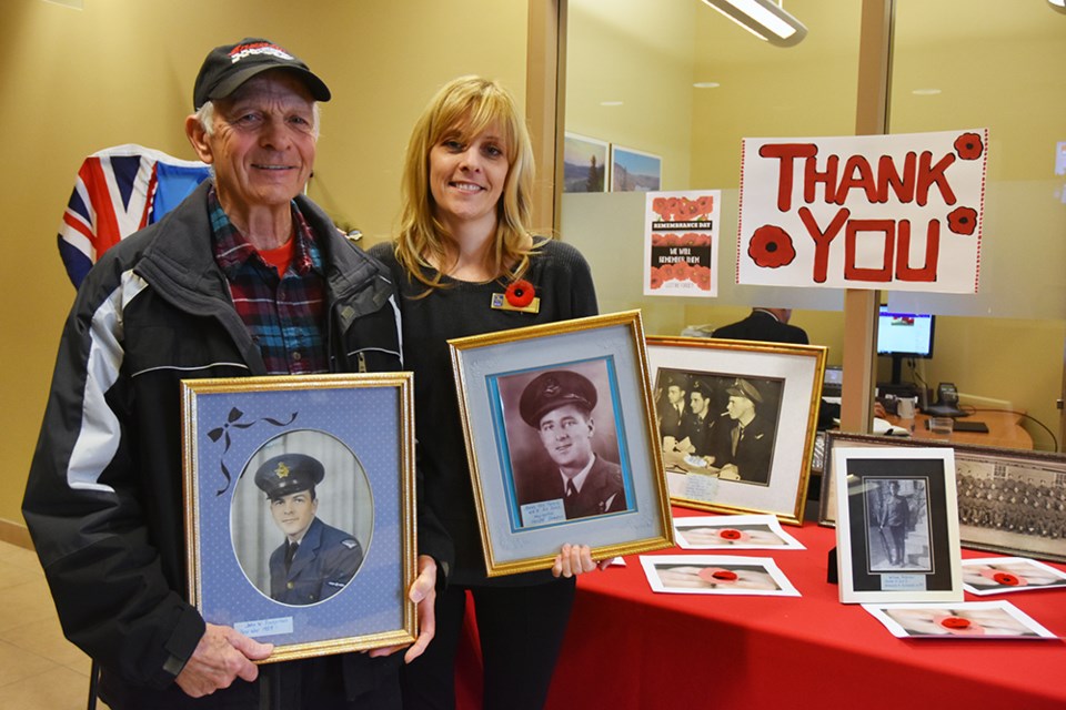 John Pinkerton holds a photo of a himself at age 20, in uniform; daughter Trisha Pinho holds a photo of her grandfather James Kay Fernie. Miriam King/BradfordToday