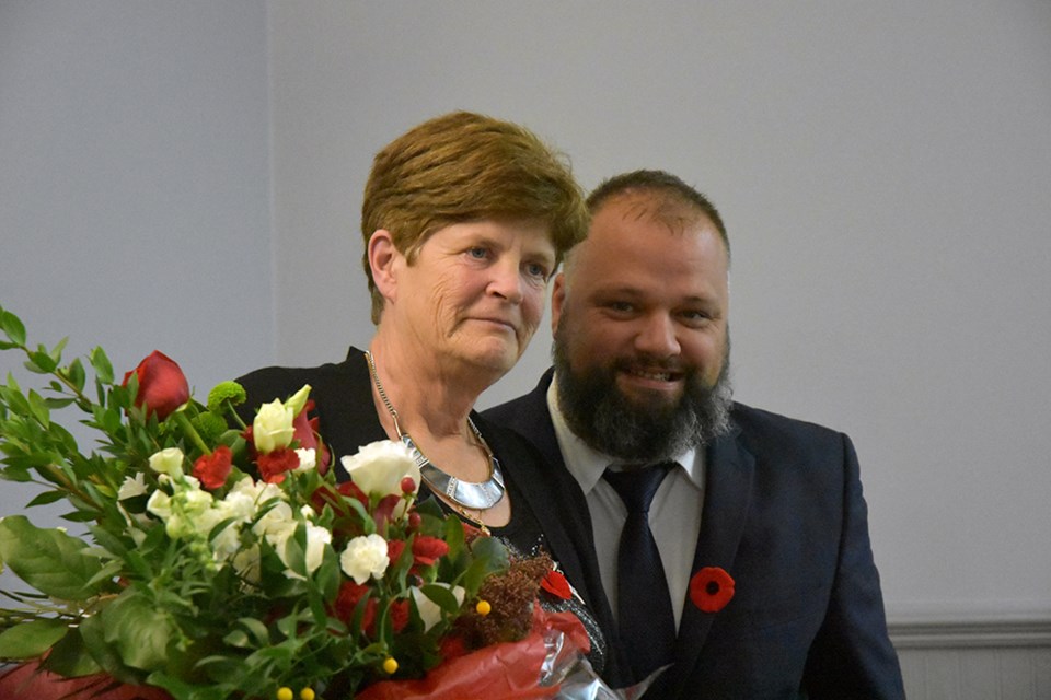 Veteran Brad Osmond presents Silver Cross Mother Carol Collier with a bouquet at the Bradford Legion's Remembrance Dinner. Miriam King/Bradford Today