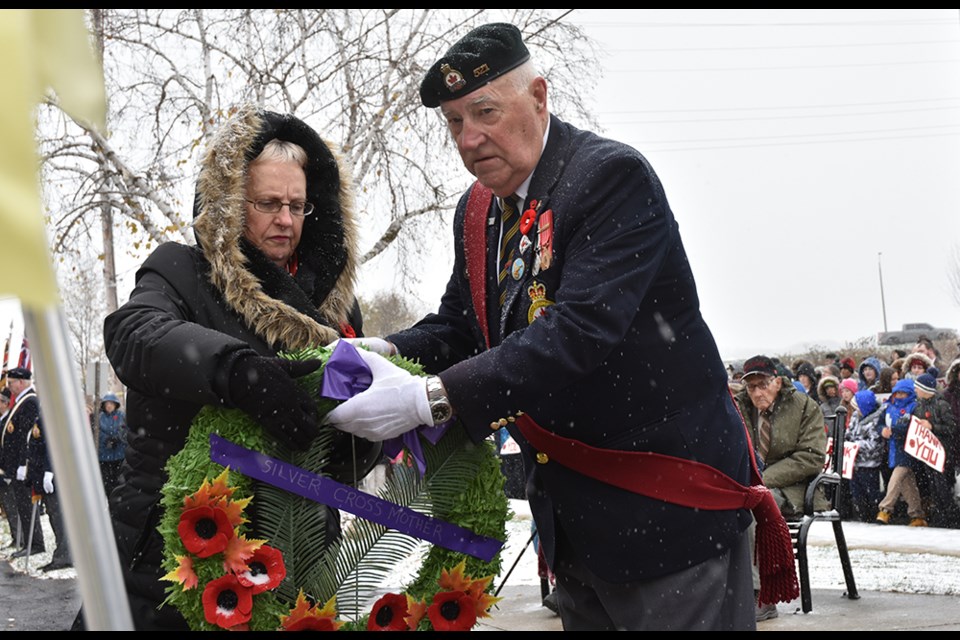 Sgt.-at-Arms George Neilson helps Legionnaire Alice Organ, representing Carol Collier, place the wreath for the Silver Cross Mother. Miriam King/Bradford Today