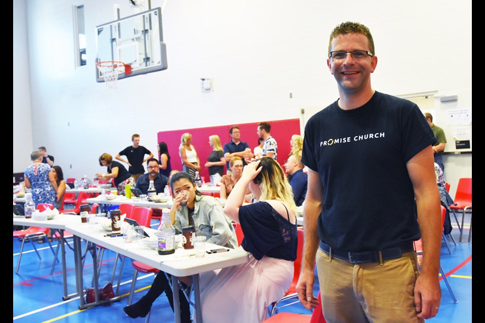 Pastor Rob Good, encouraging members of the congregation of Promise Church to socialize and get to know one another during the first church service, held Sept. 16. Miriam King/BradfordToday