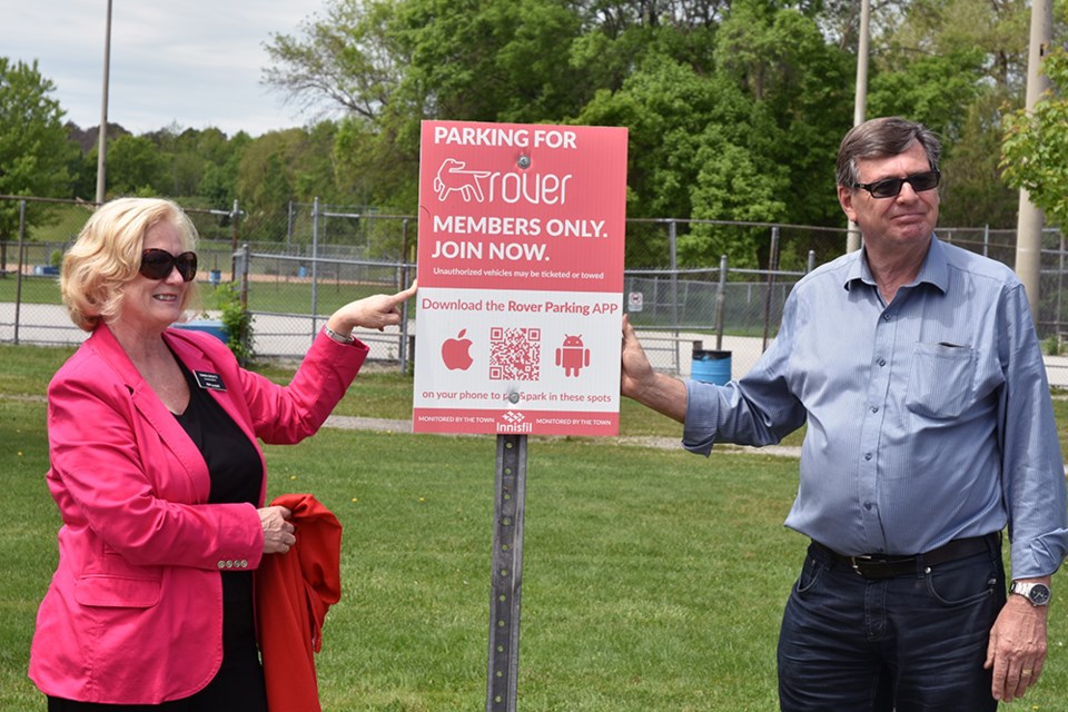 Councillor Donna Orsatti and Coun. Bill Van Berkel display one of two new Rover parking spaces at Innisfil Beach Park that can be reserved online. Miriam King/Bradford Today