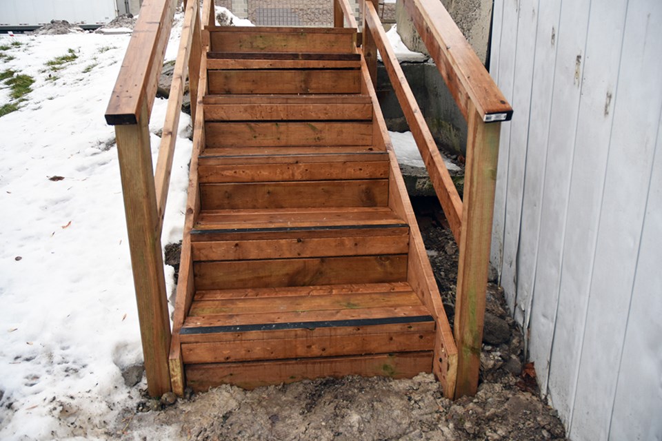 Property owner calls the freestanding structure part of the landscaping; tenant Linda Chong says they are the stairs to access her apartment unit. Miriam King/Bradford Today