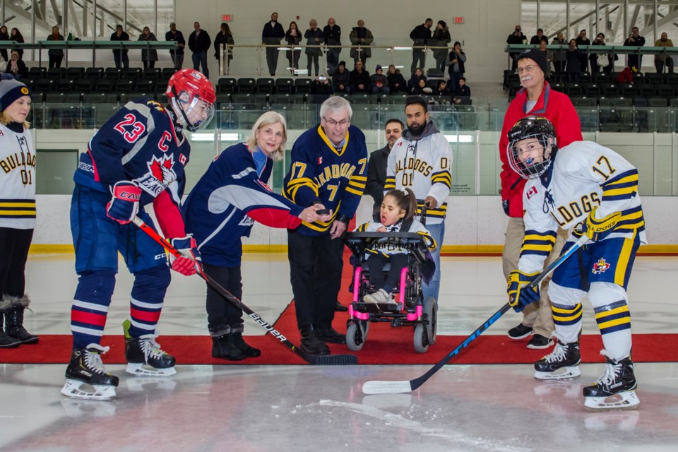 Bradford West Gwillimbury Mayor Rob Keffer and East Gwillimbury Mayor Virginia Hackson and BWG Councillor Gary Baynes joined Millie Arjoon and her parents, Jordon and Trina for the puck drop at the Battle of the Gwillilmburies. Dave Kramer for BradfordToday.