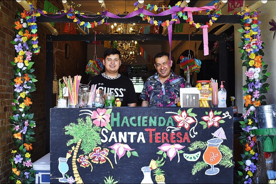 Owner Juan Angel Velazquez (left) and his Bartender from Hacienda Santa Teresa Restaurant, making delicious non-alcoholic cocktails for passerby’s on Holland Street this Saturday. Jackie Kozak for BradfordToday