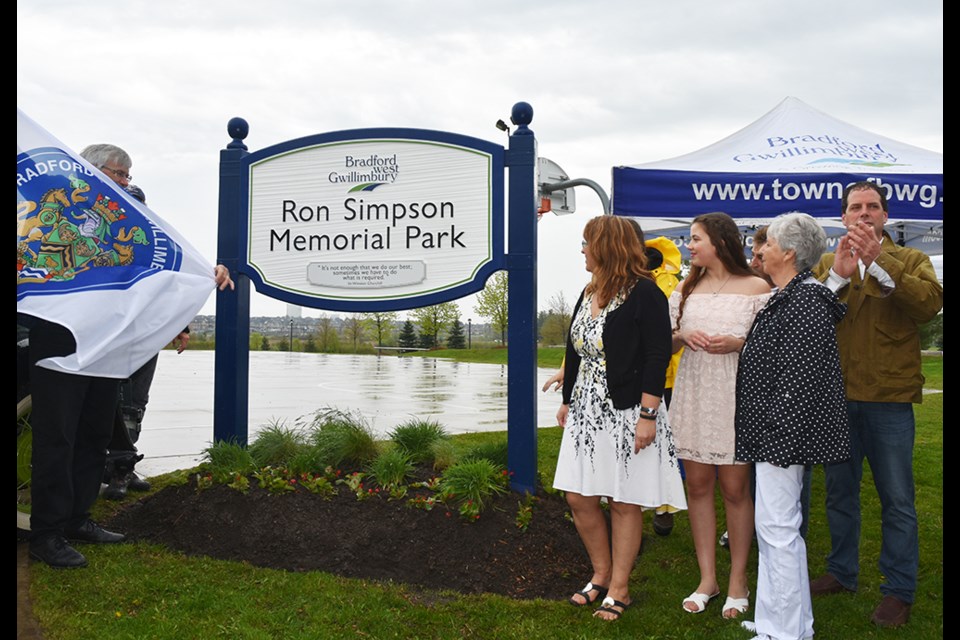 Unveiling the sign, at the renamed Ron Simpson Memorial Park, on May 25. Miriam King/Bradford Today