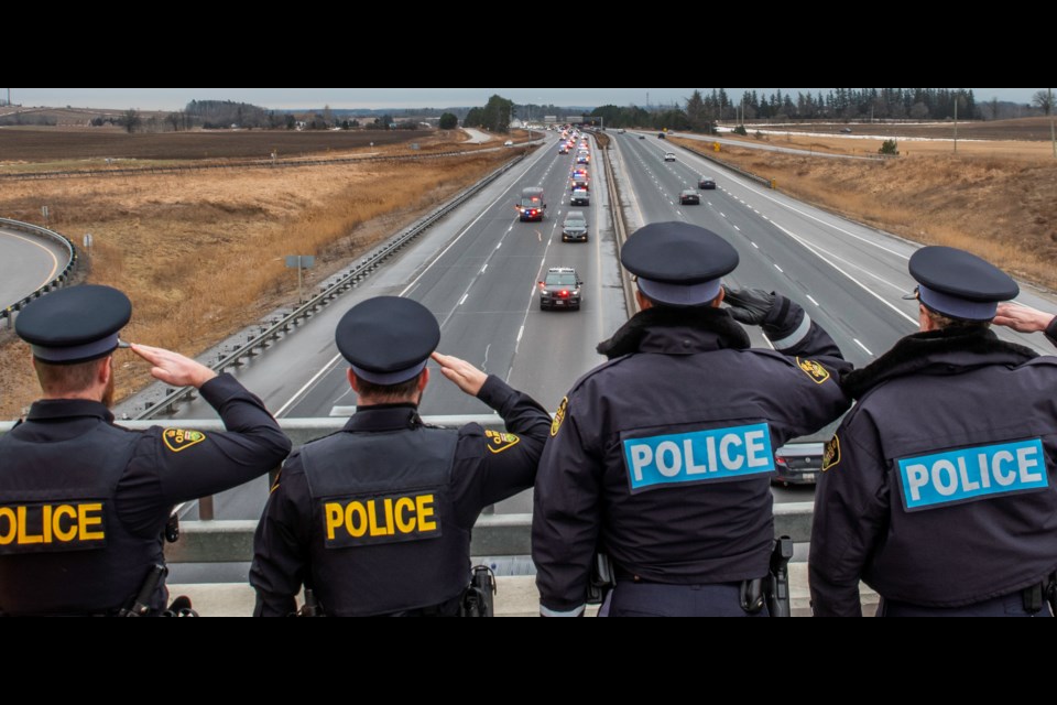 The procession to escort OPP Const. Grzegorz (Greg) Pierzchala, who was from Barrie, took place Friday morning. The procession departed from the Centre of Forensic Sciences in Toronto at 9 a.m. Friday and traveled northbound on Highway 400 to Barrie. Members of the public joined first responders, OPP, South Simcoe Police, Bradford Fire and Emergency Services and the Schomberg Fire Department in showing their respects from the Highway 88 and Line 5 Hwy 400 overpasses in Bradford.