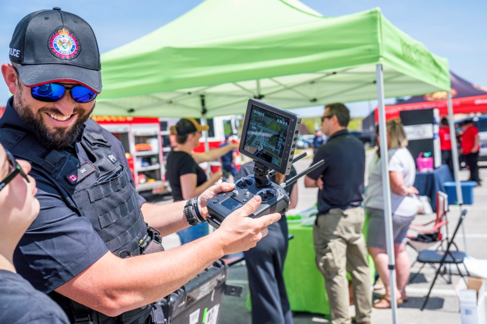 PC Cruz shows how the radio controller works with the drone at the South Simcoe Police Open House event Saturday in Innisfil. 