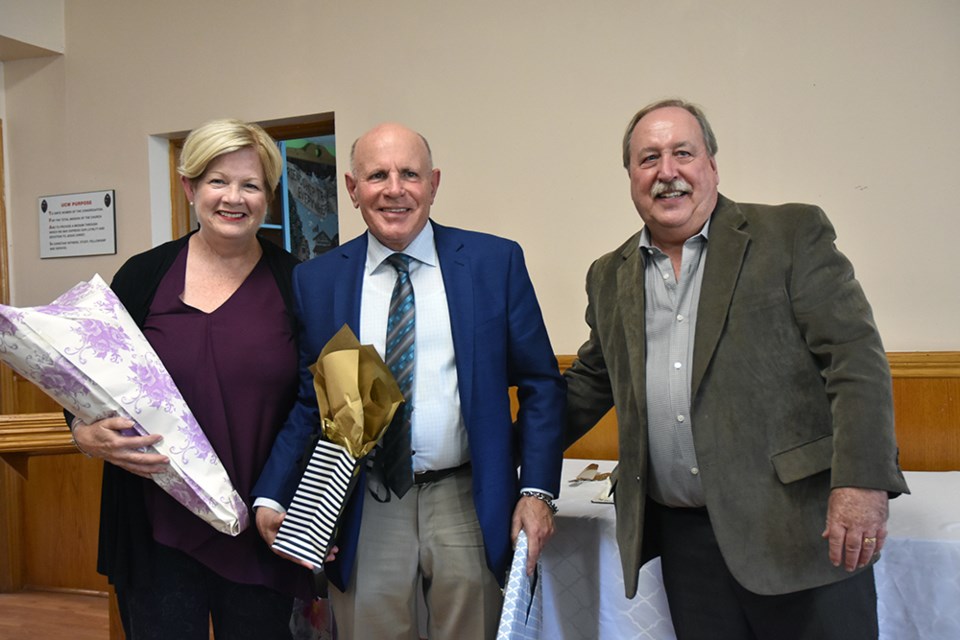 From right, Church council chair Ken Clarke presents gifts to Rev. Jim Keenan and wife Mary, on behalf of the congregation. Miriam King/Bradford Today