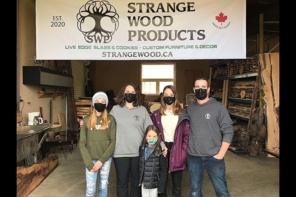 New owners of 'Strange Wood Products' Susan & Corey Ferguson and their three daughters (left-right) Claire, Emma, and Grace, were excited to celebrate the official grand opening of their new wood shop located on Simcoe Road. JackieKozak/BradfordToday. 