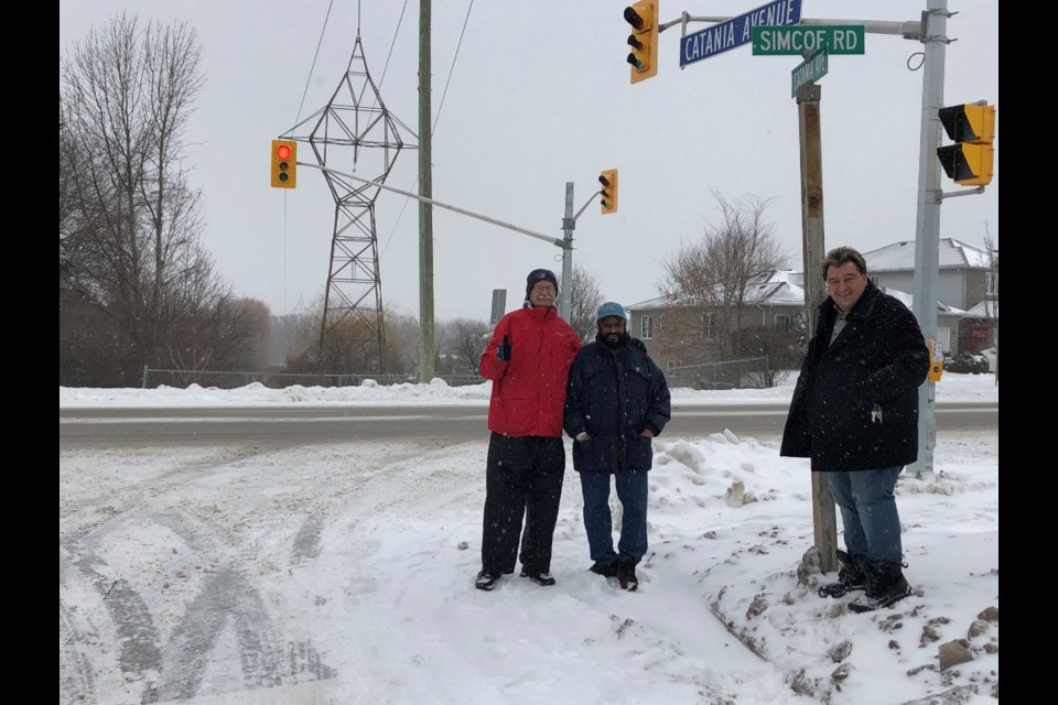 Coun. Gary Baynes, resident, Darshan Bilkhu and Coun. Peter Dykie at the corner of Catania Avenue and Simcoe Road Saturday afternoon, where a new set of lights have been added to now make it a fully signalized intersection. Natasha Philpott/BradfordToday