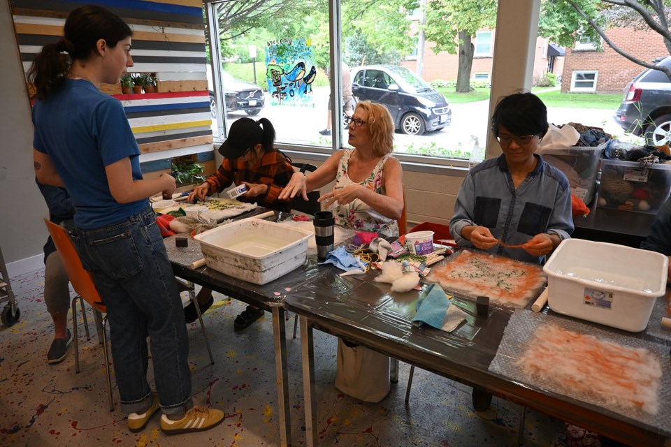 Emily Chudnovsky (left), a textile-based artist who turns microplastics into artwrok, led the group.