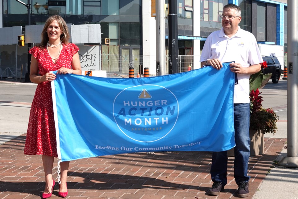 Burlington Mayor Marianne Meed Ward and Burlington Food Bank Executive Director Robin Bailey get read to raise the Hunger Action Month flag at Burlington City Hall this morning (Sept. 5). The month-long initiative aims to address food insecurity in the community. 