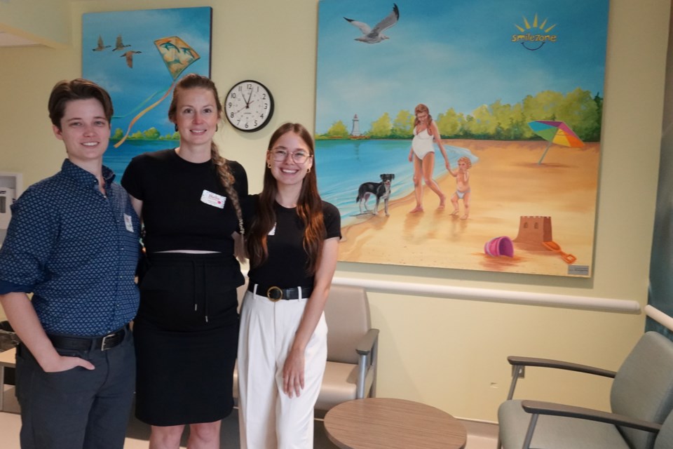 Joseph Brant Hospital celebrated the opening of a new Smilezone in its Maternal and Child program space. The artists who painted the JBH Smilezone (from left): Jude Phillips, Sarah Carlson and Katie Sokolova.