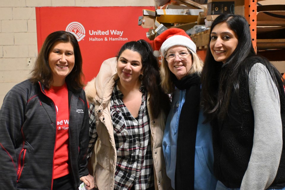 (Left to right) Kristen Jacob, Kayla Willert, Jennene Robinson and Gavan Badh helped to collect and organize dropped off gifts.