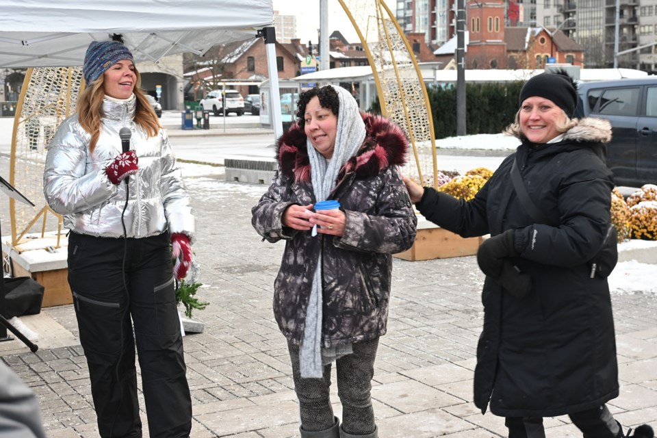 (Left to right) Monica Graves, Alexandra Guthrie and Judie Kavanagh smile as Kavanagh donates the prize tree to Guthrie.