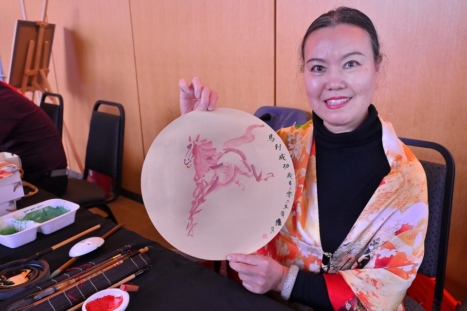 Chinese New Year celebrations for Year of the Snake were put on by Redleaf Cultural Integration at the Burlington Performing Arts Centre Saturday afternoon. Ansheng Yu making Chinese watercolour paintings to give to attendees. The horse brings future success.