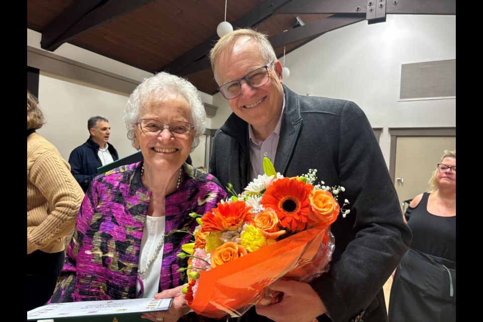 MP Peter Julian presented Gerda Suess with a certificate and flowers at the Group of Five's recent fundraiser.