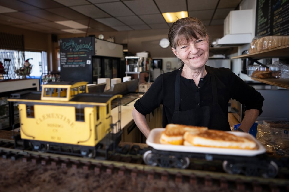 Leona Green puts lunch on a train - to deliver it to customers at her Sapperton deli.