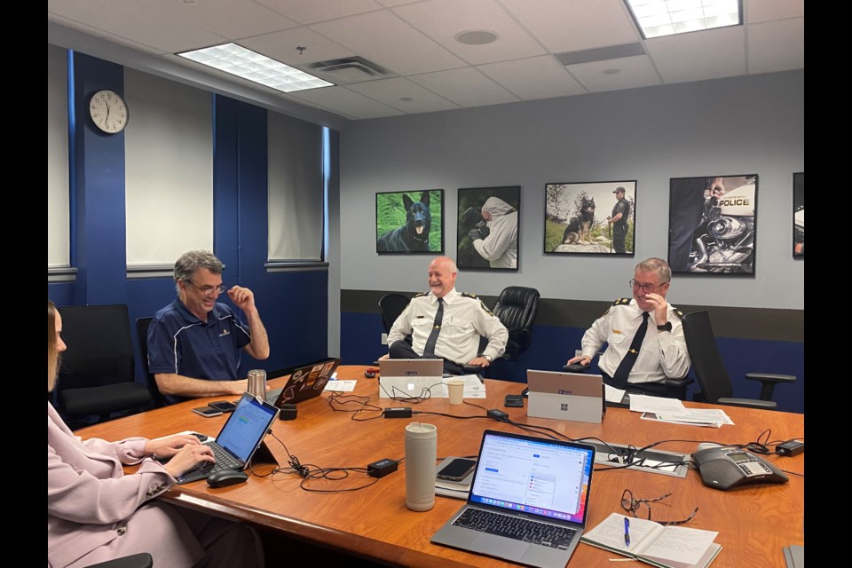 Mayor Patrick Johnstone, Chief Const. Dave Jansen and Deputy Chief Const. Paul Hyland, from left, share a laugh at the June 18 police board meeting.