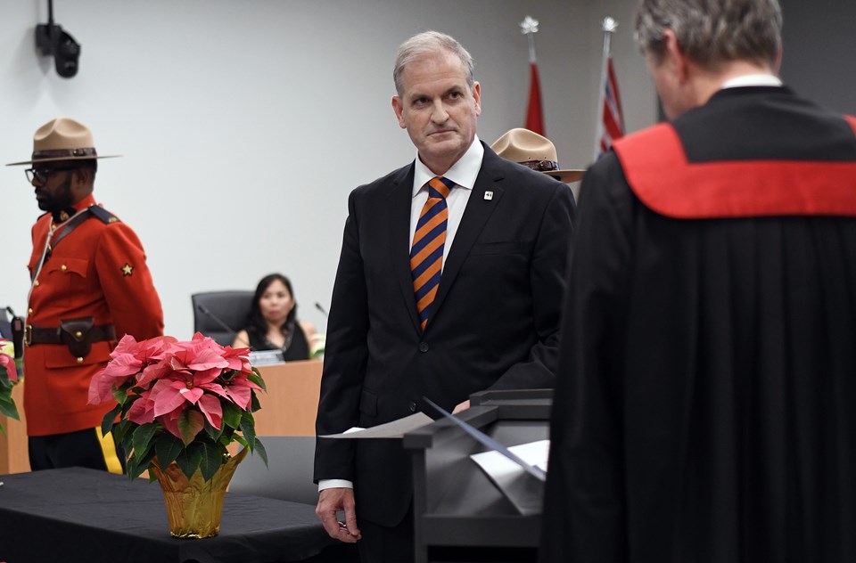 Trustee Bill Brassington, the Burnaby school board's new chair, takes the oath of office at a meeting Tuesday evening. 