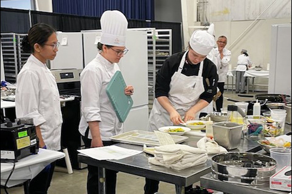 Burnaby Central Secondary Grade 12 student Sarah Taylor, right, competes in cooking at Skills Canada BC in Abbotsford last month.