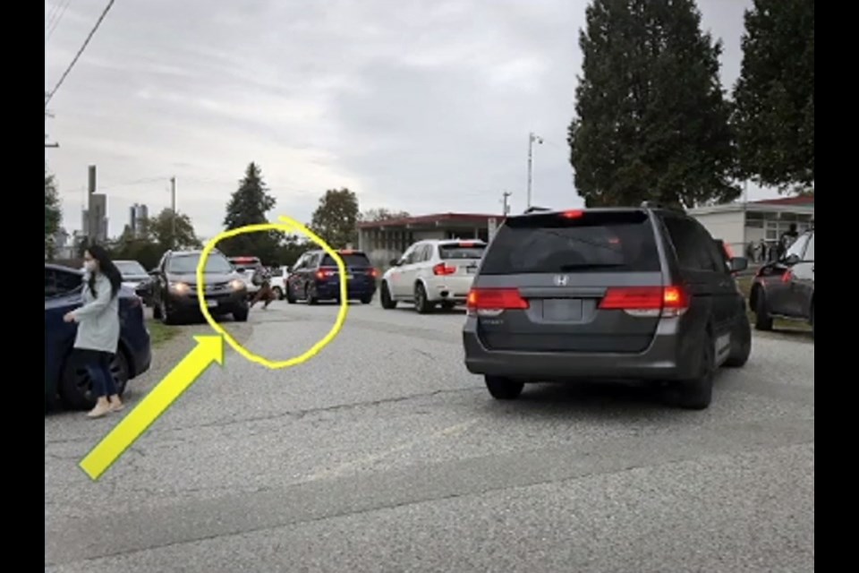 A photo presented to the city's traffic safety committee shows a Sperling Elementary School student dashing across a crowded road to get to school.