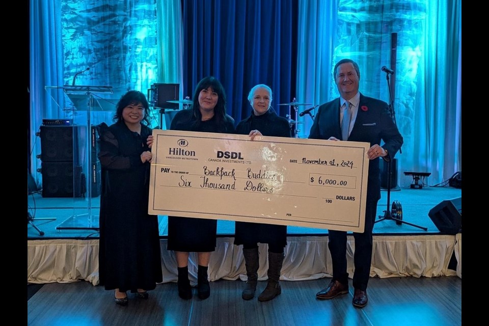 Hilton Vancouver Metrotown representatives presented a $6,000 cheque to Backpack Buddies as part of the 2024 Festival of Trees fundraiser.