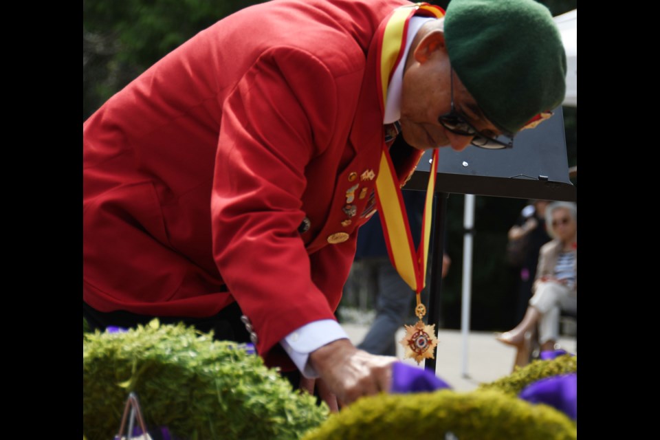 Ted Jung of the Korean Marine Corp. lays a poppy on a wreath in remembrance of the Korean War.