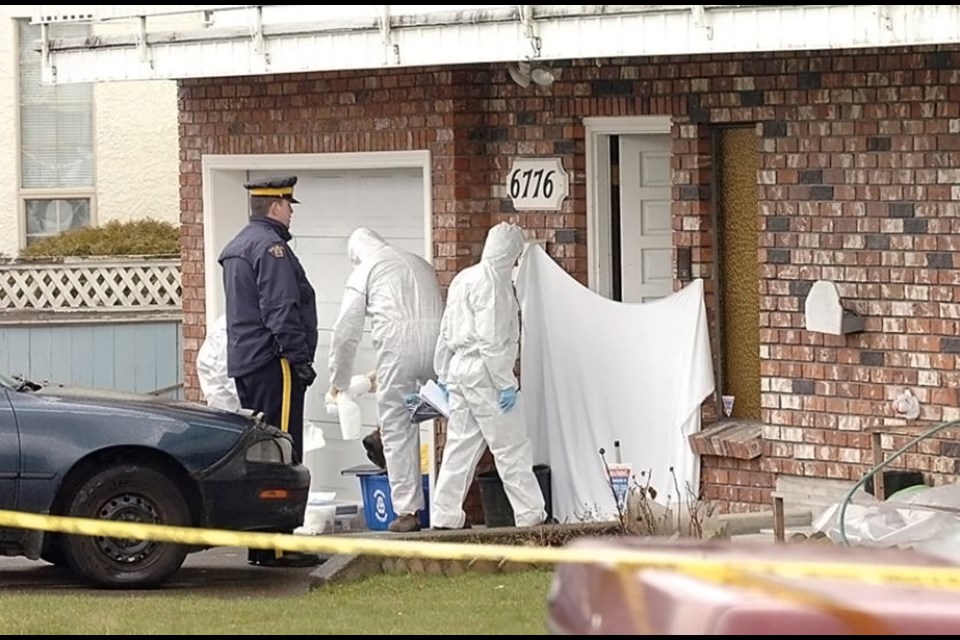 Homicide investigators scour a unit in a Colborne Avenue fourplex in March 2009 after the discovery of Kimberly Halgarth's body inside.