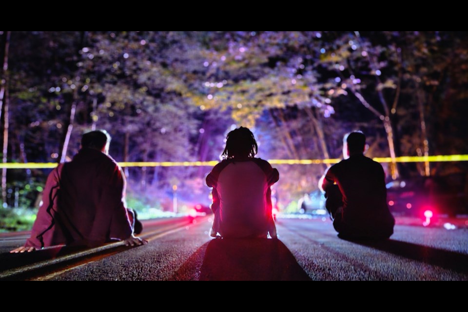 Visitors to Burnaby Mountain Park wait for Centennial Way to reopen after a motorcycle crash Tuesday night.