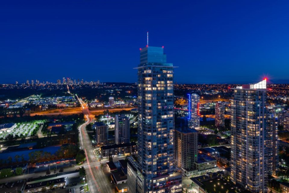 The towers of Burnaby's Brentwood Town Centre illuminated at night.