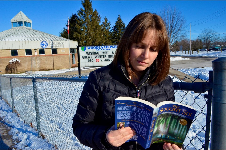 Cambridge children’s author Catherine Klug outside Woodland Park Public School in Hespeler where she was inspired to write the Sought Six fantasy series 