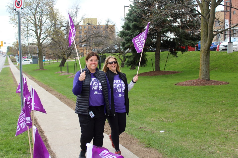 Healthcare workers waved flags up and down Coronation Blvd to protest for improved working conditions.