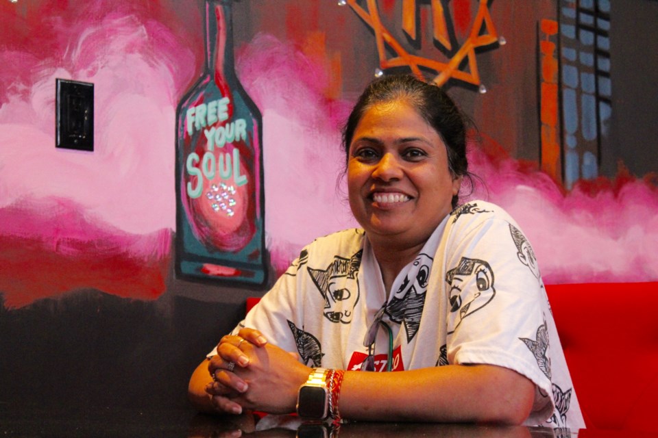 Co-owner of Rowdy's Bar and Restaurant Annie Saini sits in front of one of her favourite sayings "Free Your Soul." She hopes the new restaurant will be a space where people can let loose and have fun.