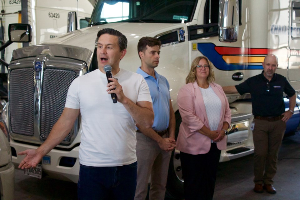 Pierre Poilievre speaks to the workers at Challenger Motor Freight alongside Kitchener-South Hespeler Conservative candidate Matt Strauss and Cambridge MP candidate Connie Cody. 