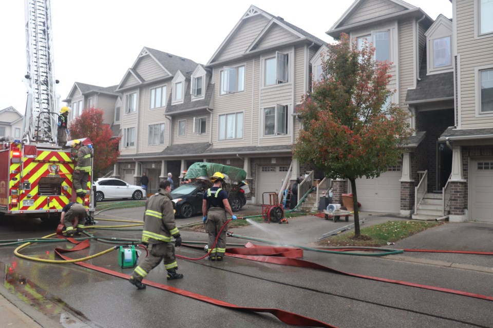 Fire crews clean up after extinguishing the Shlueter Street fire