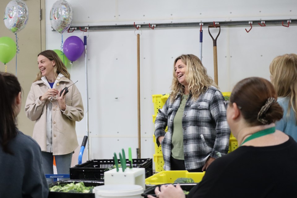 Andrea Slipek(left) and Elaine Merkus talk to volunteers at the Ontario Christian Gleaners