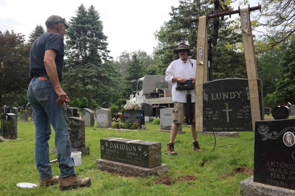 Contractors fix toppled tombstones at Mount View Cemetery in Galt on Wednesday, May 22.