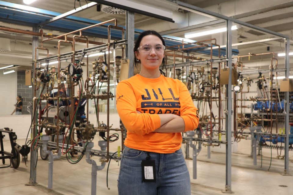 Hannah Paasila stands in the plumbing shop at Conestoga's skilled trades campus in Cambridge 