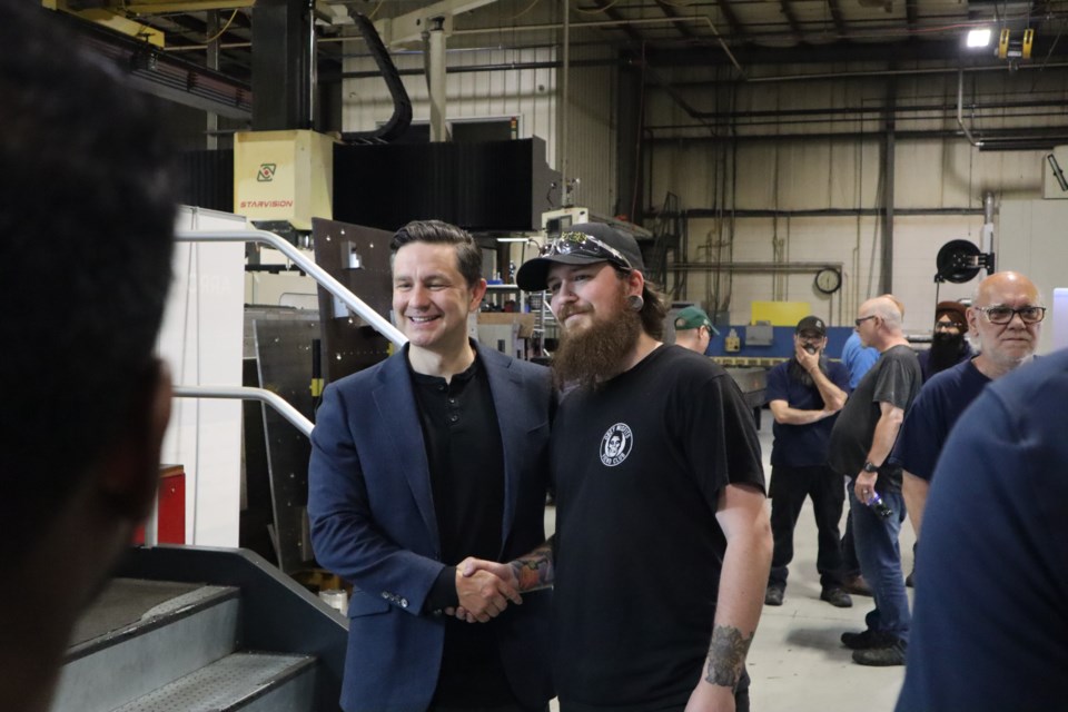 Conservative Party leader Pierre Poilievre meets with workers at Arrow Engineered Products in Cambridge on Friday.