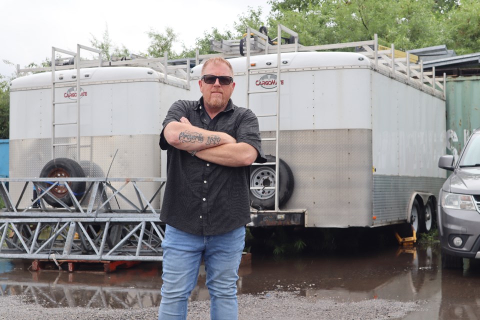 Vic Berzins owner of Nabatech Communications Ltd. stands in front of trailers that keep getting broken into.