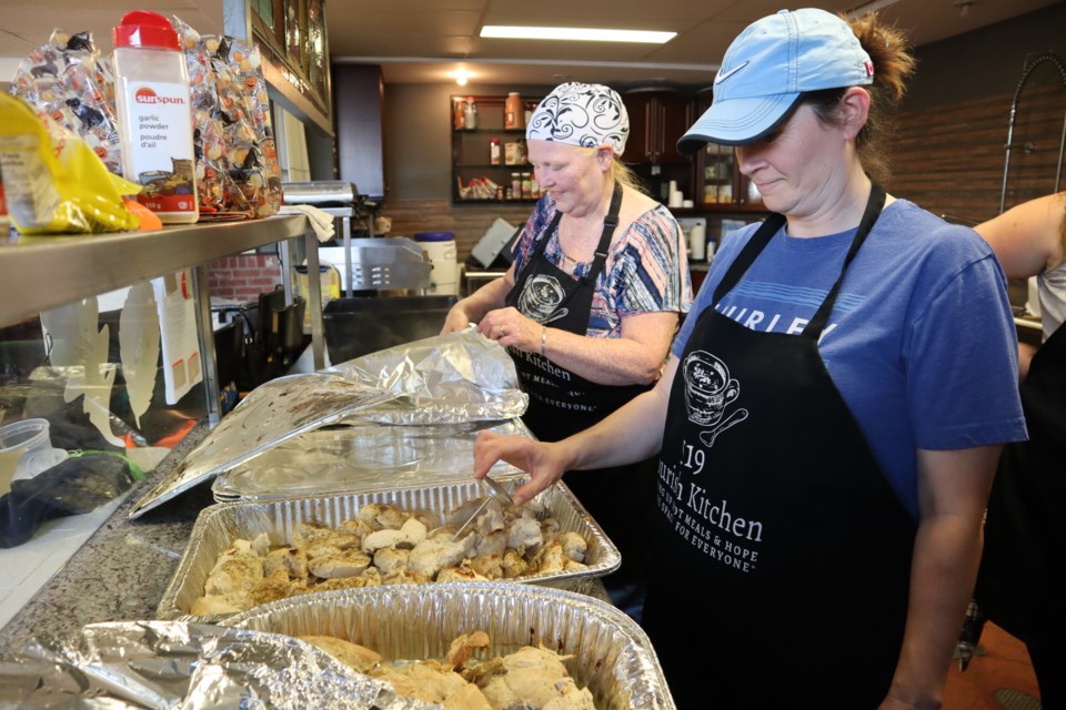 Volunteers check the temperature of the cooked turkey.