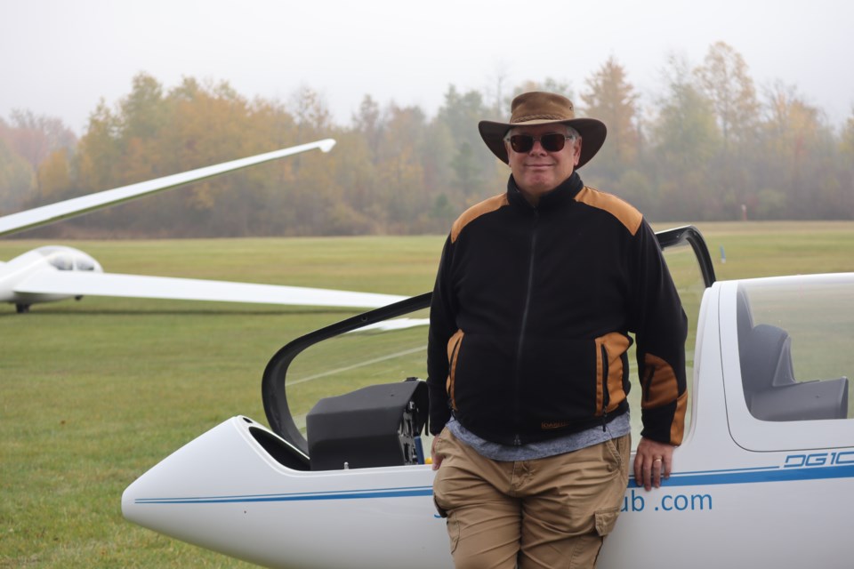 Bob Harvey stands next to his glider for the day