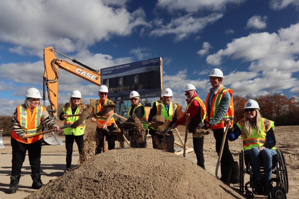 Cambridge Mayor Jan Liggett and Cambridge city council toss the ceremonial dirt into the air to kick off construction.