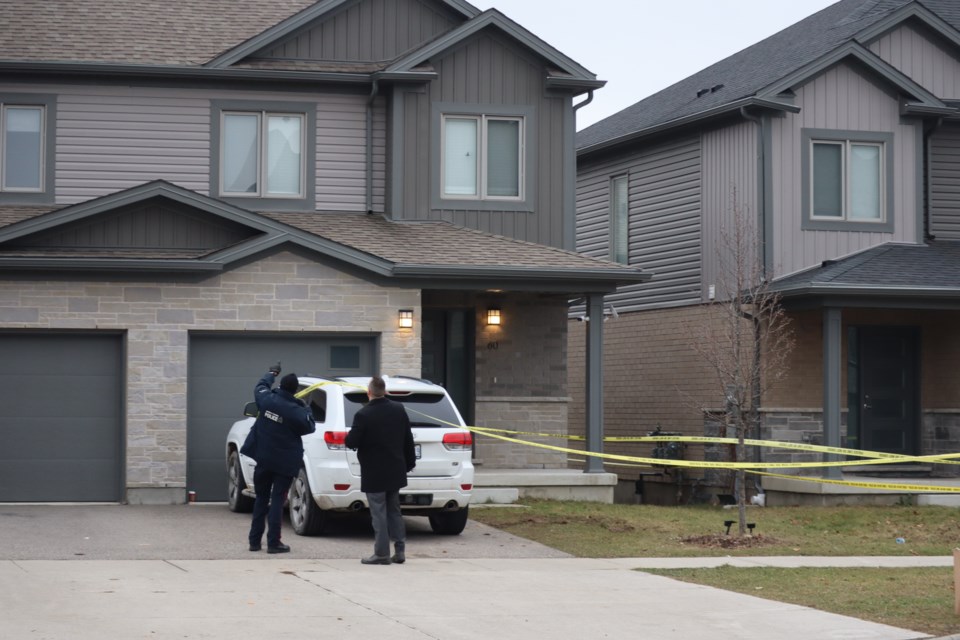 Police search the exterior of the home for damages 